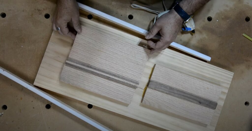 Cutting wood pieces of the serving board.