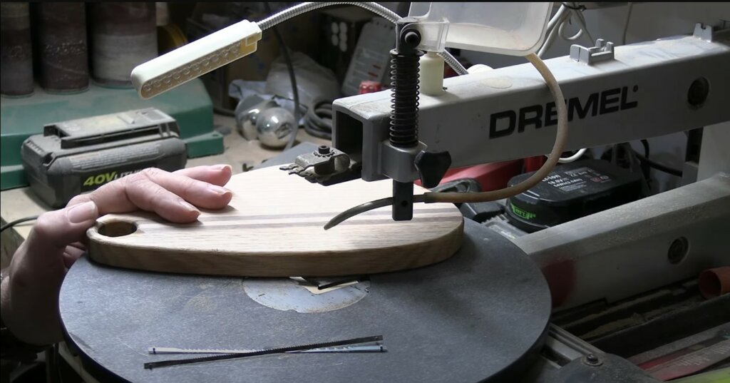 Cutting the shape of the serving board with a scroll saw.